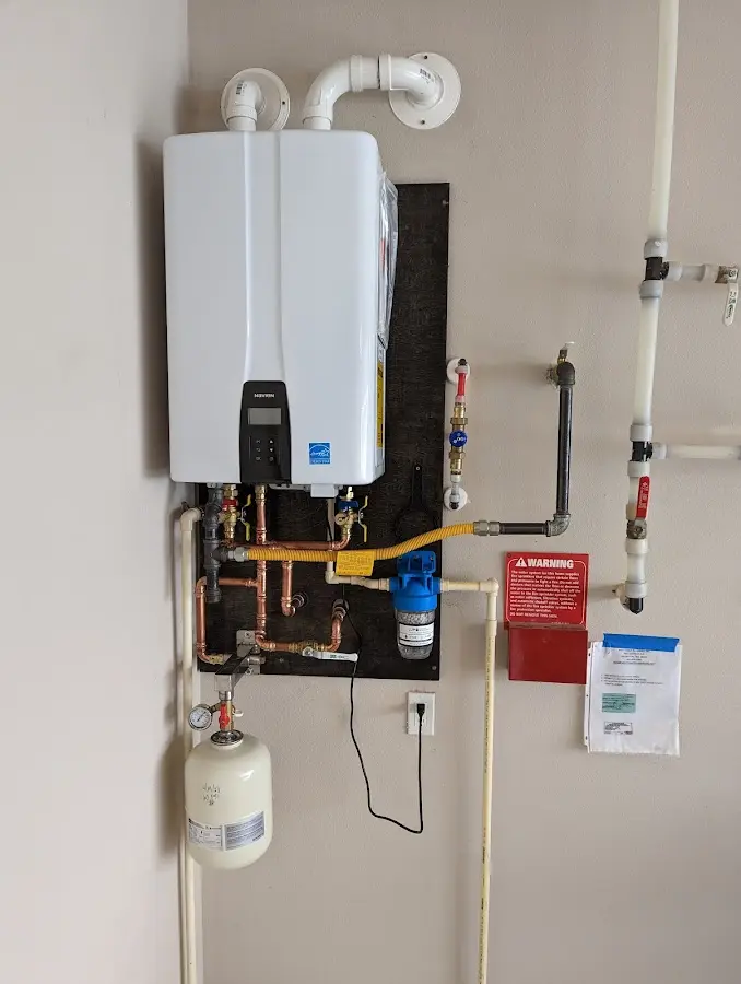 Professional plumber installing copper piping in a Baytown home